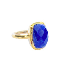 Load image into Gallery viewer, A gold-colored brass ring with a faceted blue Lapis Lazuli gemstone.