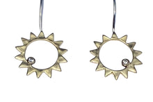Load image into Gallery viewer, A pair of sterling silver earrings with brass sun motifs and clear zirconia embellishments.
