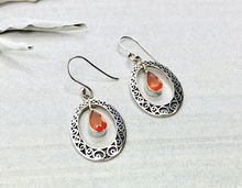 Load image into Gallery viewer, Silver earrings with teardrop-shaped orange stones on a light gray background