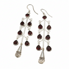 Load image into Gallery viewer, Silver earrings with red gemstones on a gray background